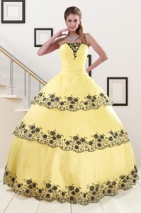 Light Yellow Quinceanera Dress With Appliques And Ruffled Layers